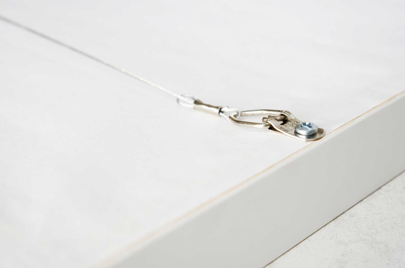 Close-up of a metal clip on a white background