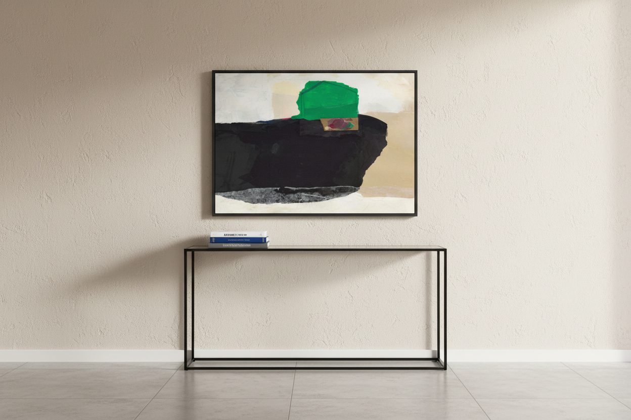 An abstract framed wall art print hangs on a textured beige wall above a minimalist black console table. The artwork features a large black shape with a bright green block and beige sections.