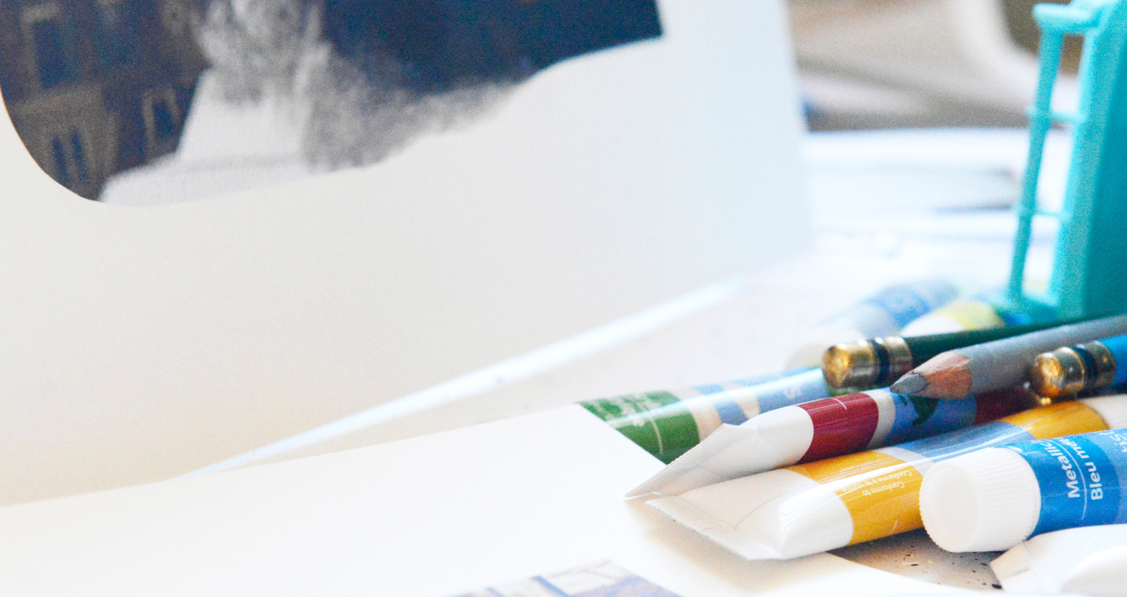 Paint tubes and collage materials in Libby Saylor's art studio workspace