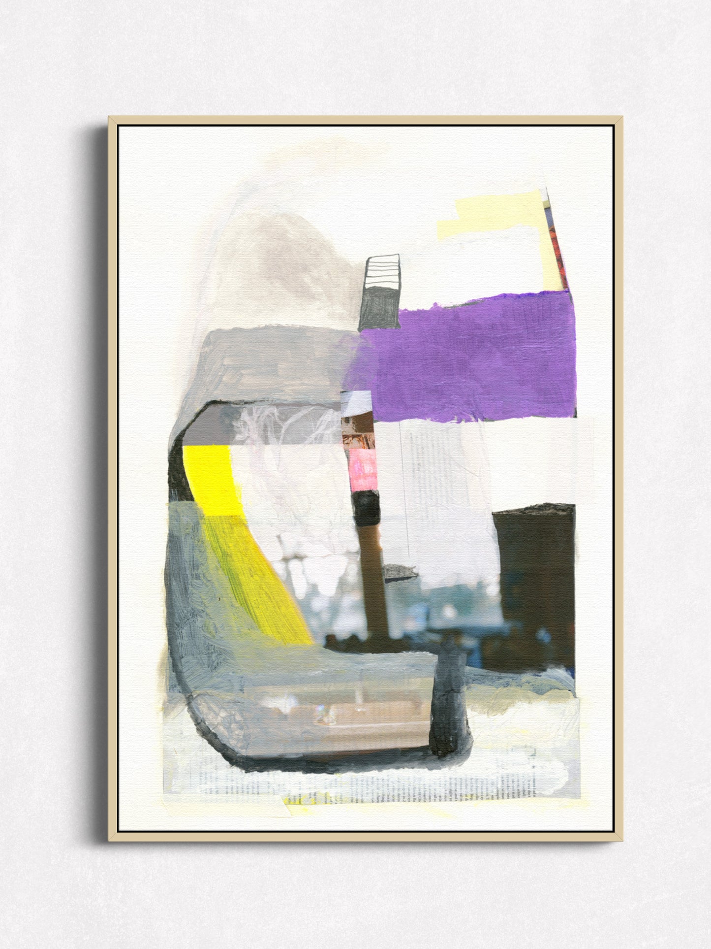 An abstract framed wall art print featuring layered geometric and painterly shapes in purple, gray, black, yellow, white, and soft blue tones, displayed against a light neutral wall.