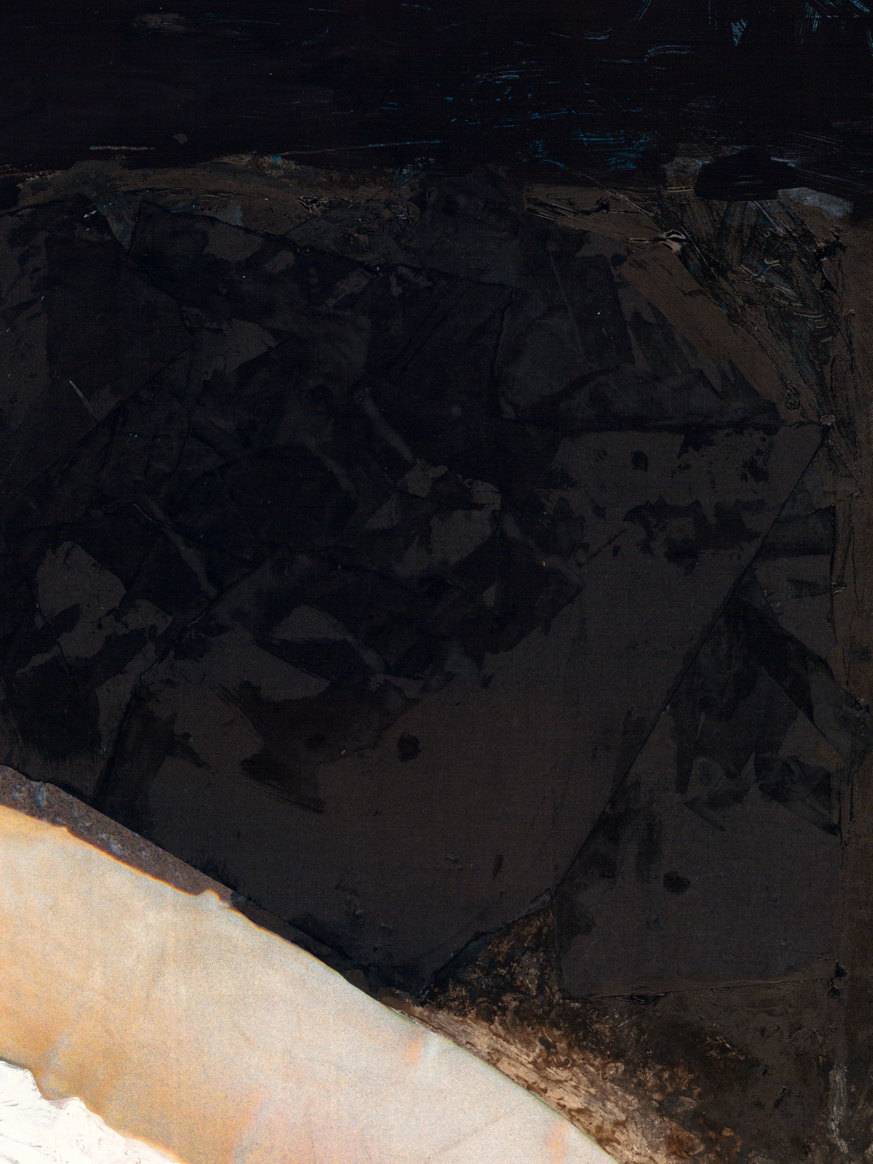 Close-up of a textured black surface with a white edge