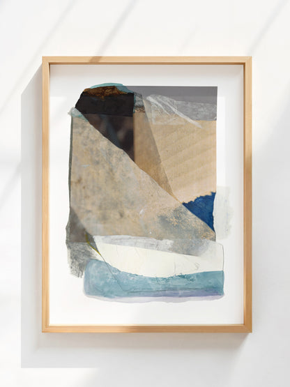 Framed abstract art with beige, blue, gray, and white organic shapes. 
