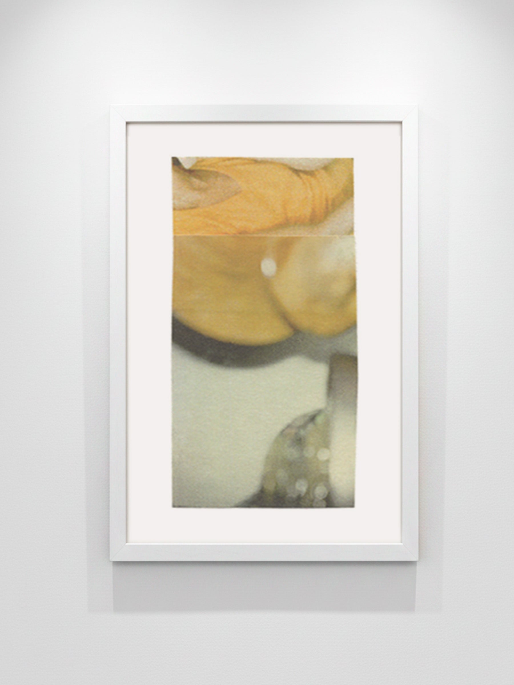 A framed abstract art print featuring soft, painterly shapes in muted yellow, beige, gray, and brown tones, displayed on a light gray wall.