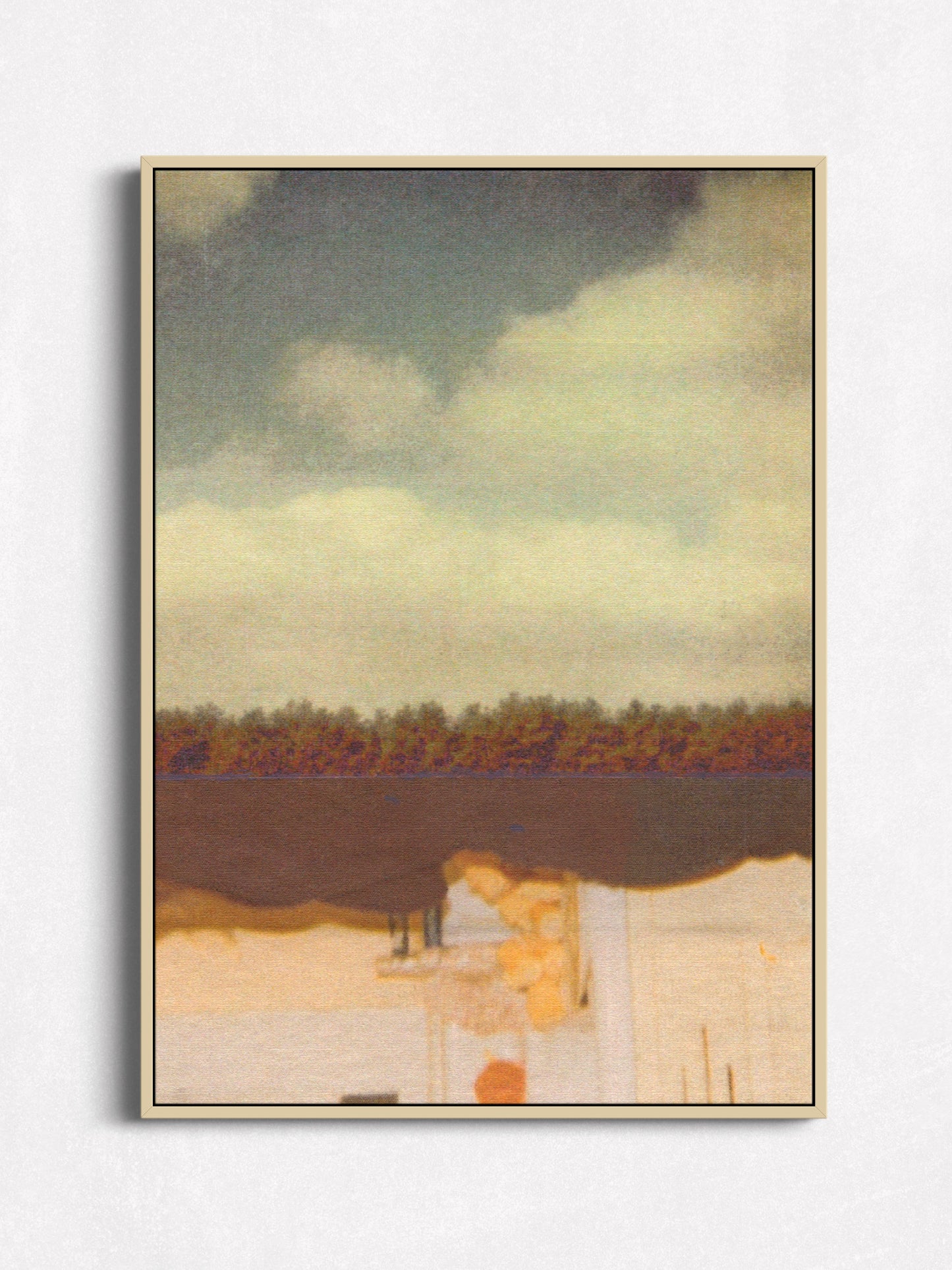 A framed landscape art print featuring a cloudy sky, a dark horizontal band, and a pale foreground with abstract architectural forms, displayed against a light gray wall.