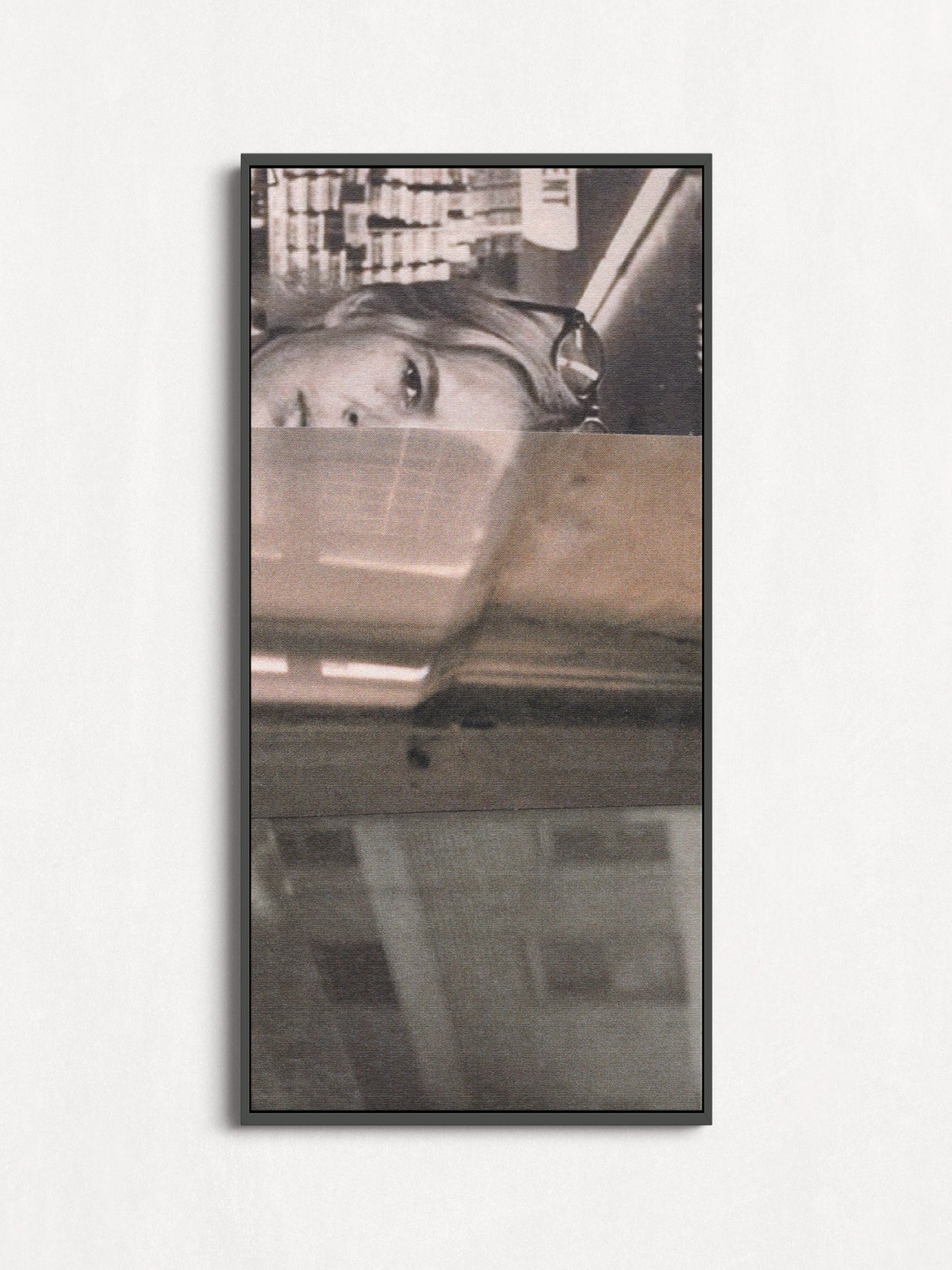 Canvas print of black and white photo collage of a woman with a cityscape in a black frame.