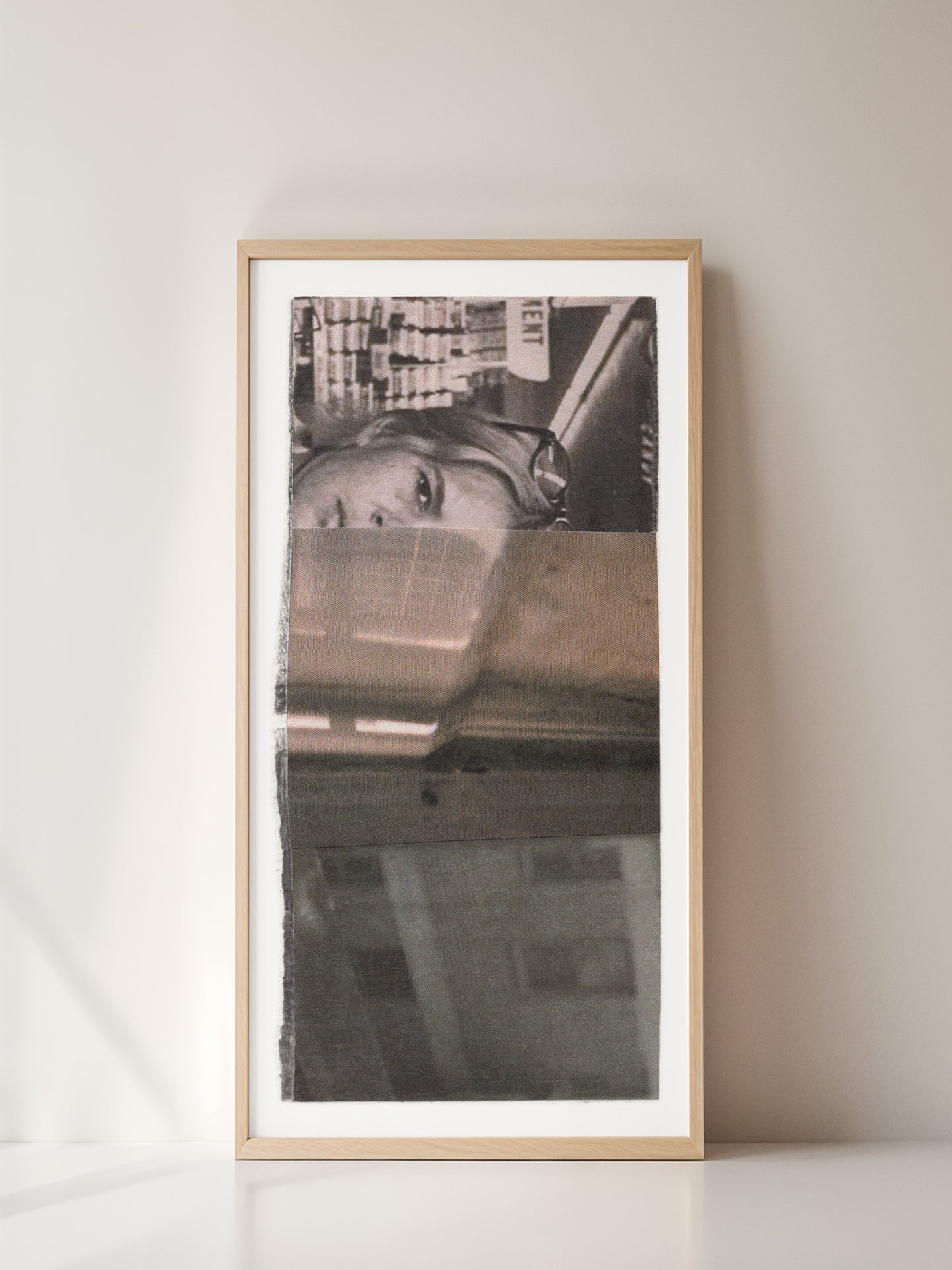 Framed black and white photo collage of a woman with a cityscape background.