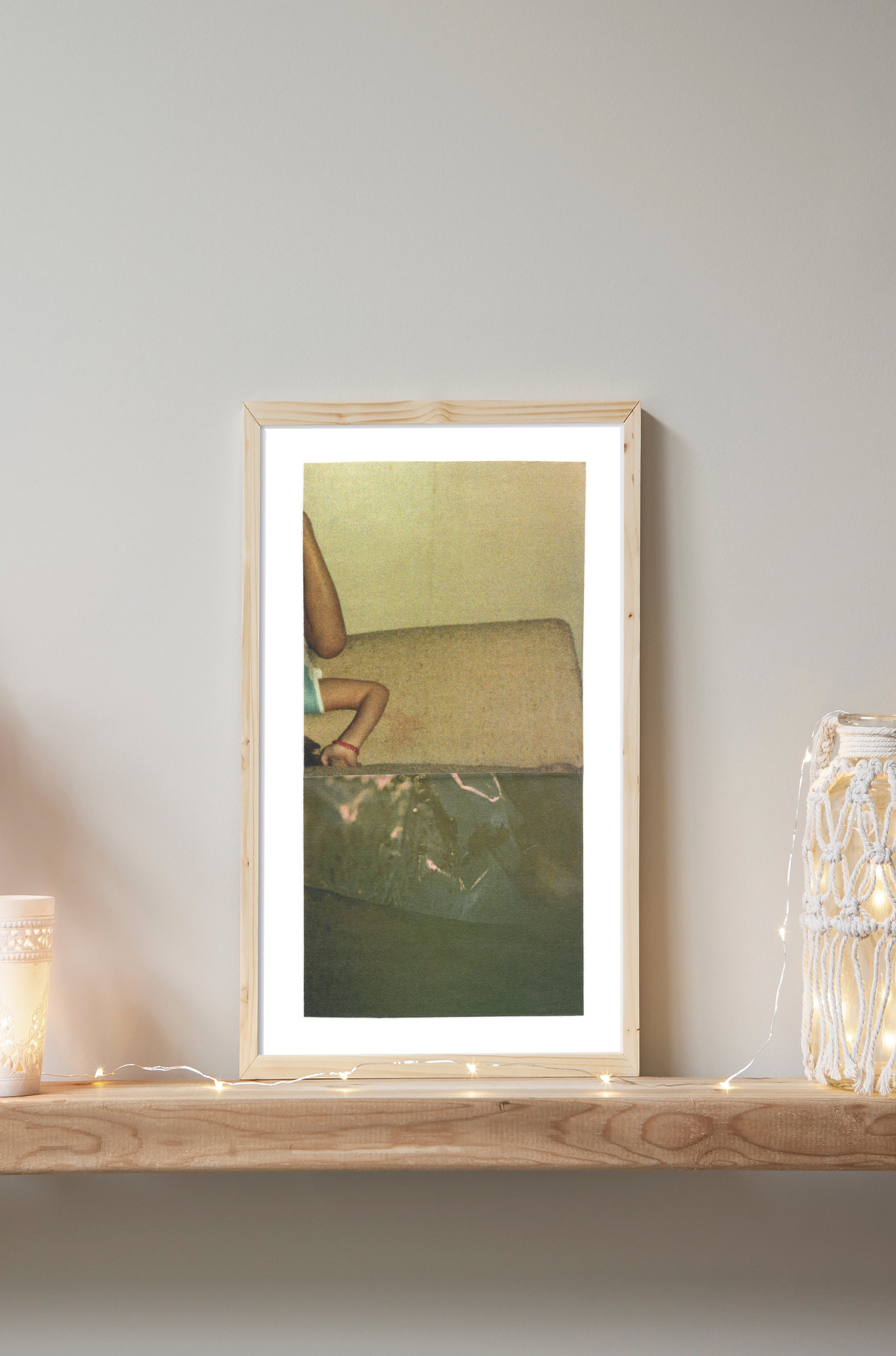 Abstract photo collage art with an upside down child and greenish textures in a wood frame.