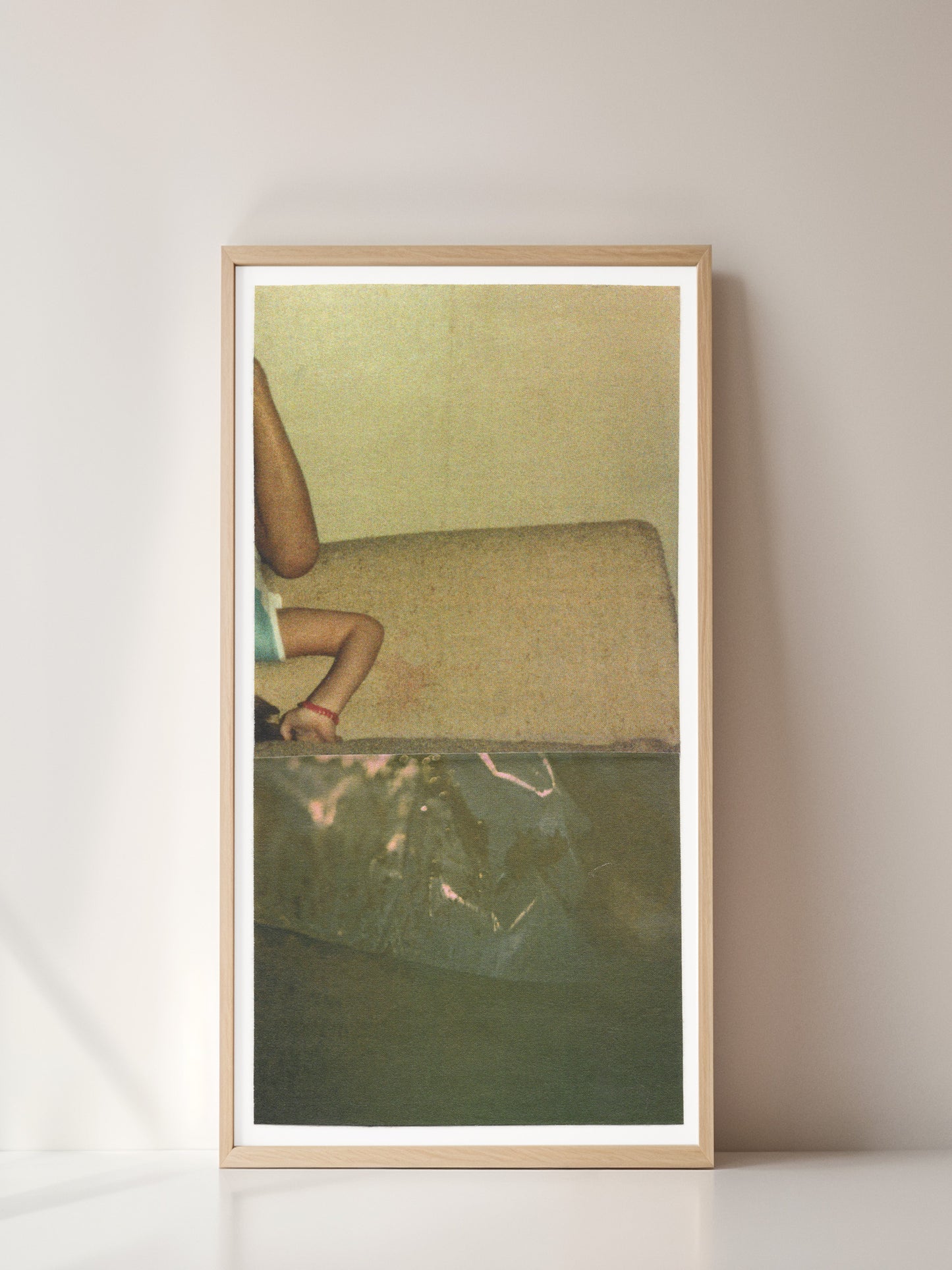 Framed print of sage green abstract photo collage with an upside down small child.