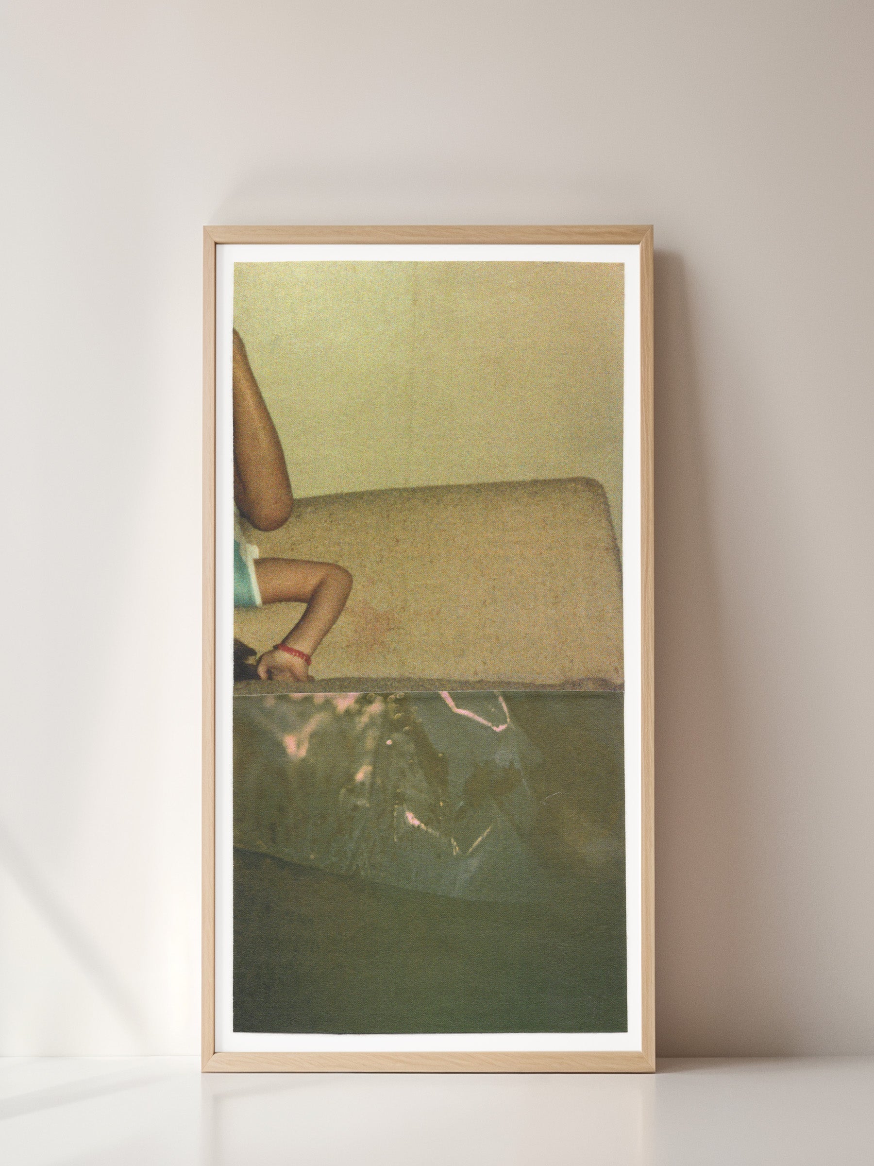 Framed print of sage green abstract photo collage with an upside down small child.