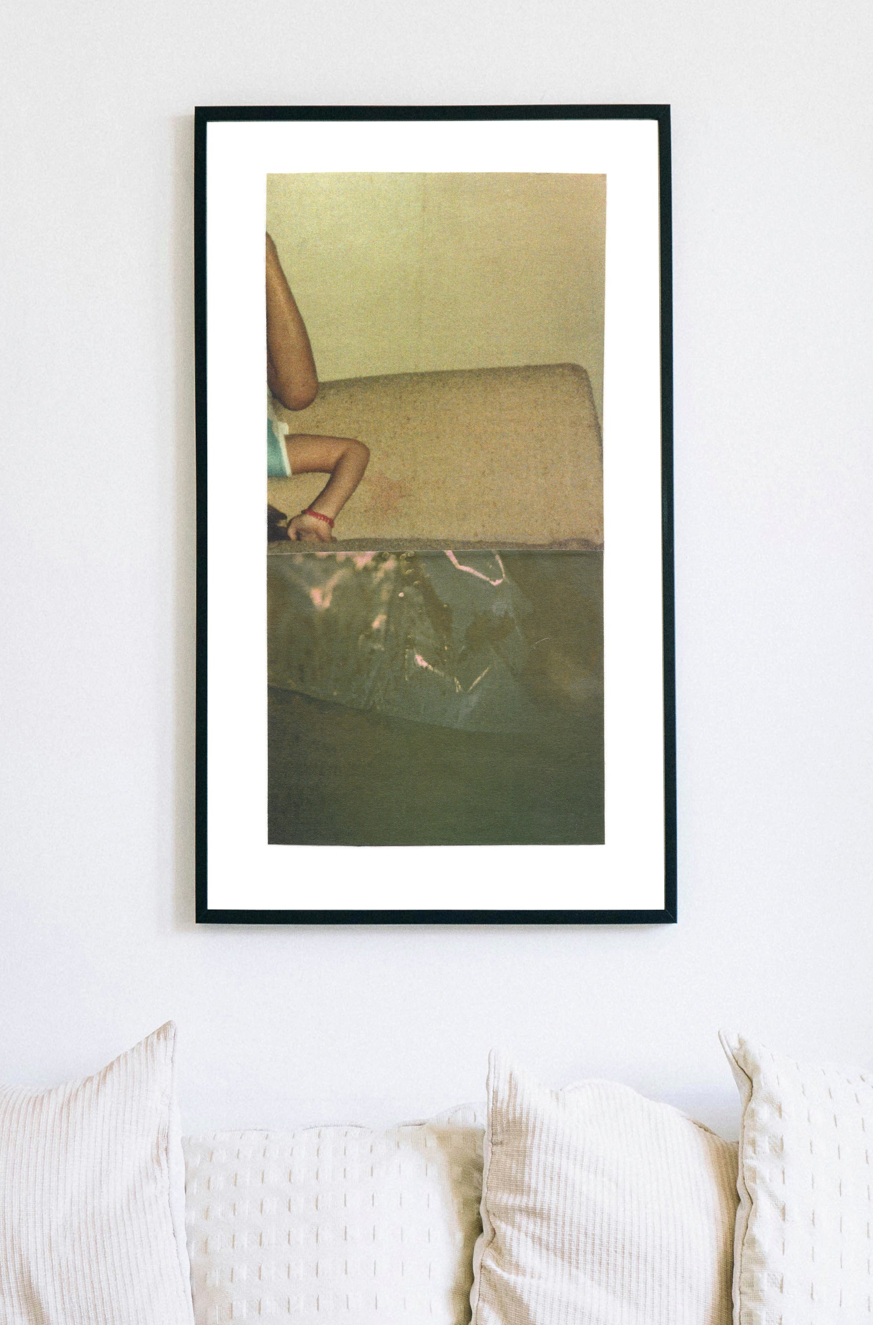 Abstract photo collage art with an upside down child and greenish textures in a black frame.