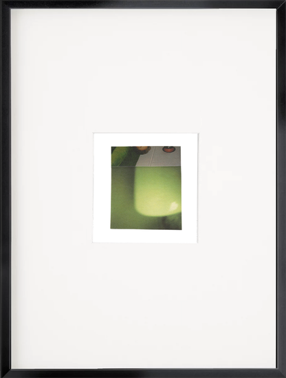 Framed abstract photo collage featuring figurative elements with luminous green-yellow atmospheric tones and soft gradients.