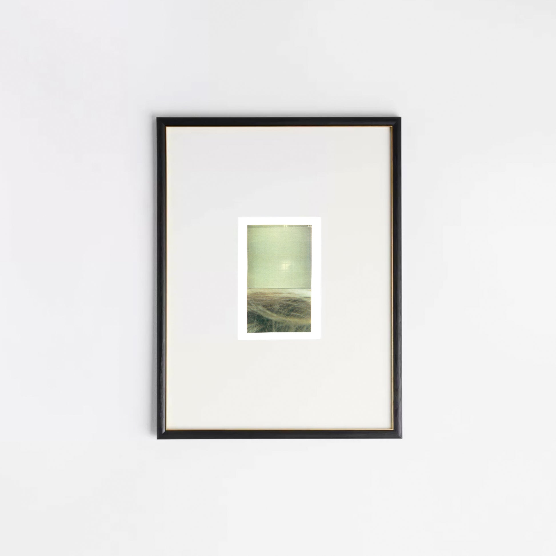 Abstract photo collage in muted greens, taupes, and golden tones in a black frame.