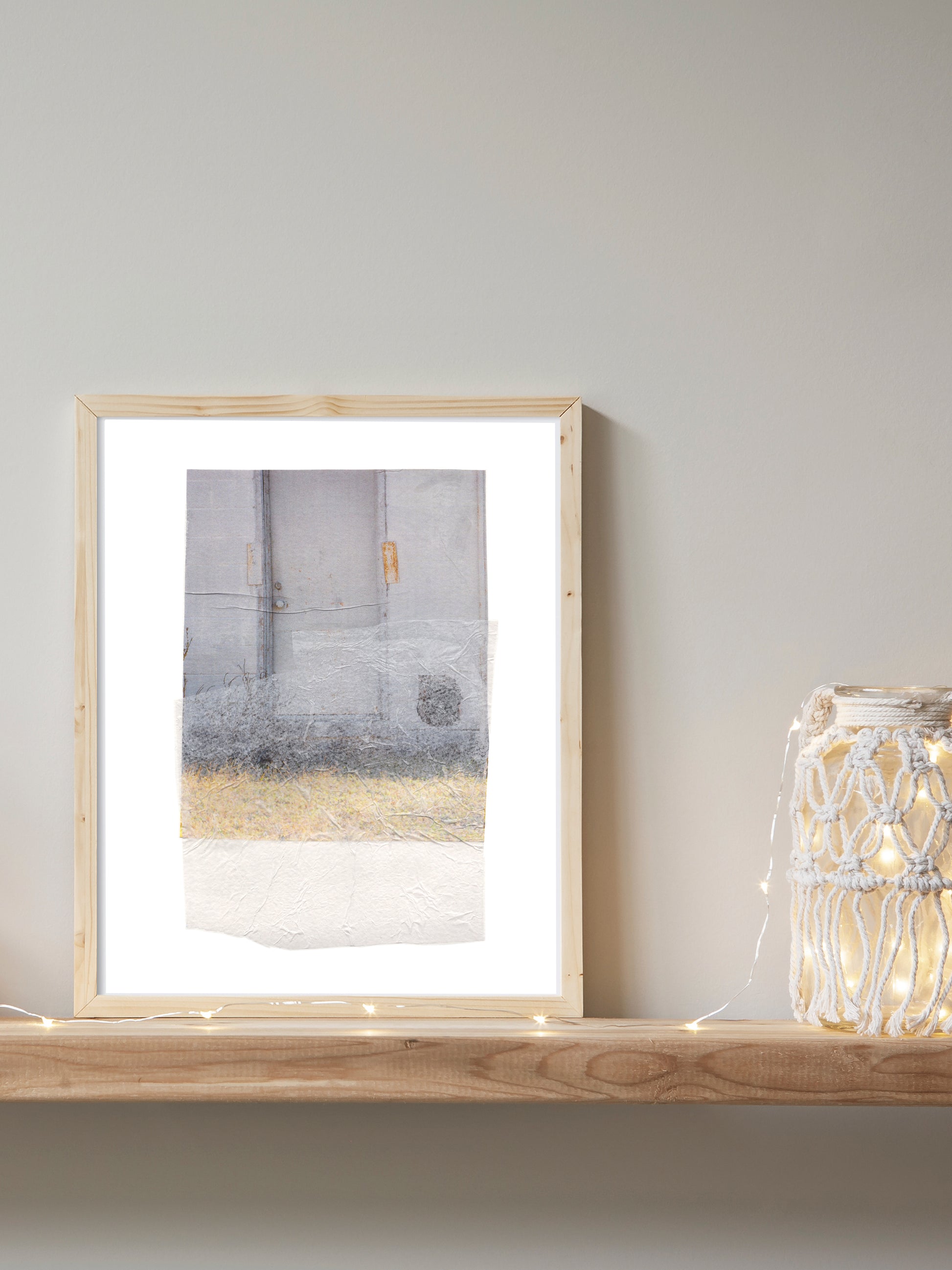 Abstract collage with soft earth tones and a textured surface in a wood frame.