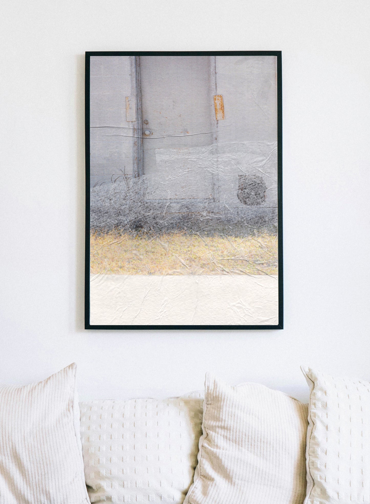 Framed canvas print of abstract collage with soft earth tones and a textured surface.