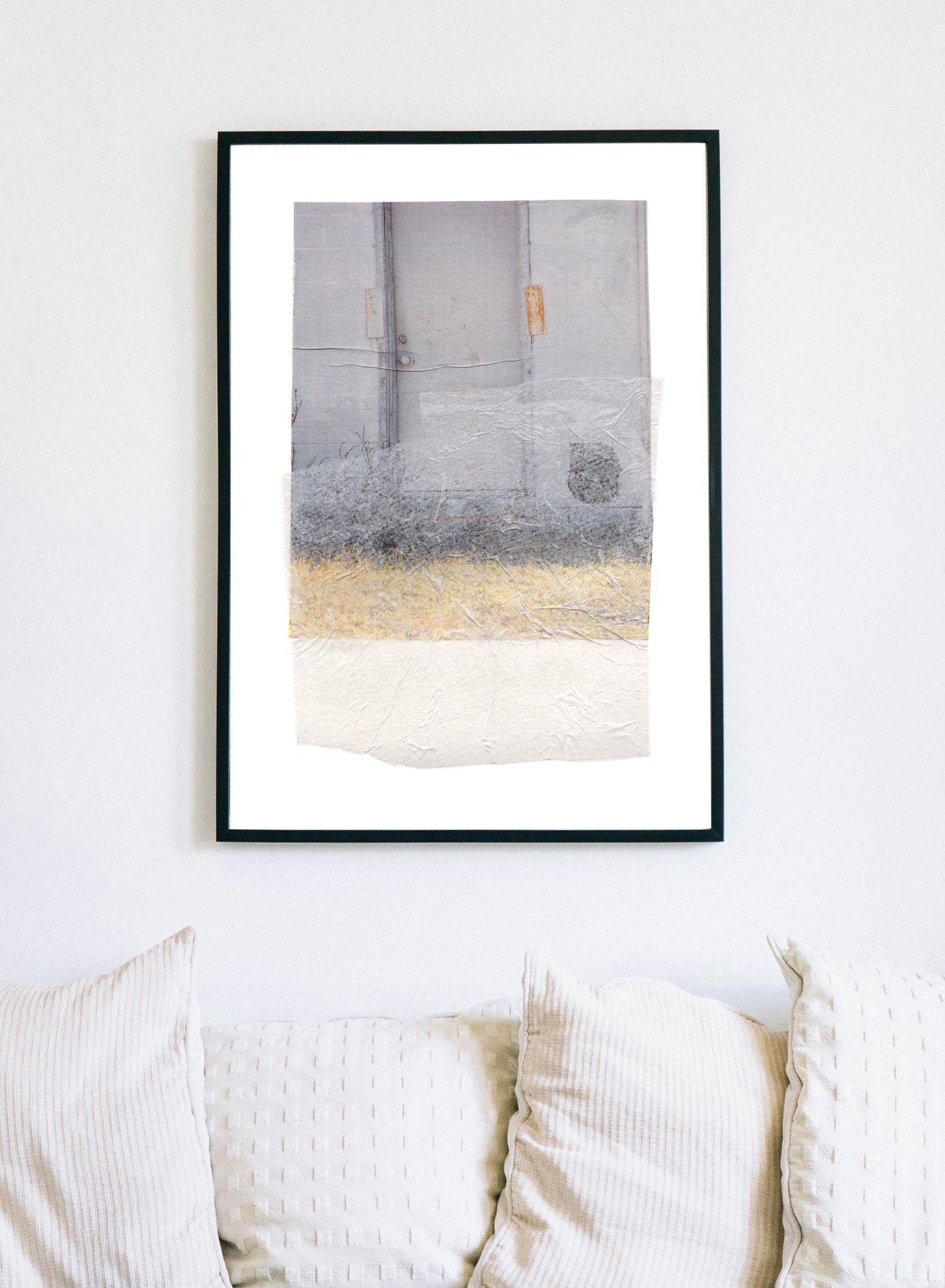 Abstract collage with soft earth tones and a textured surface in a black frame.