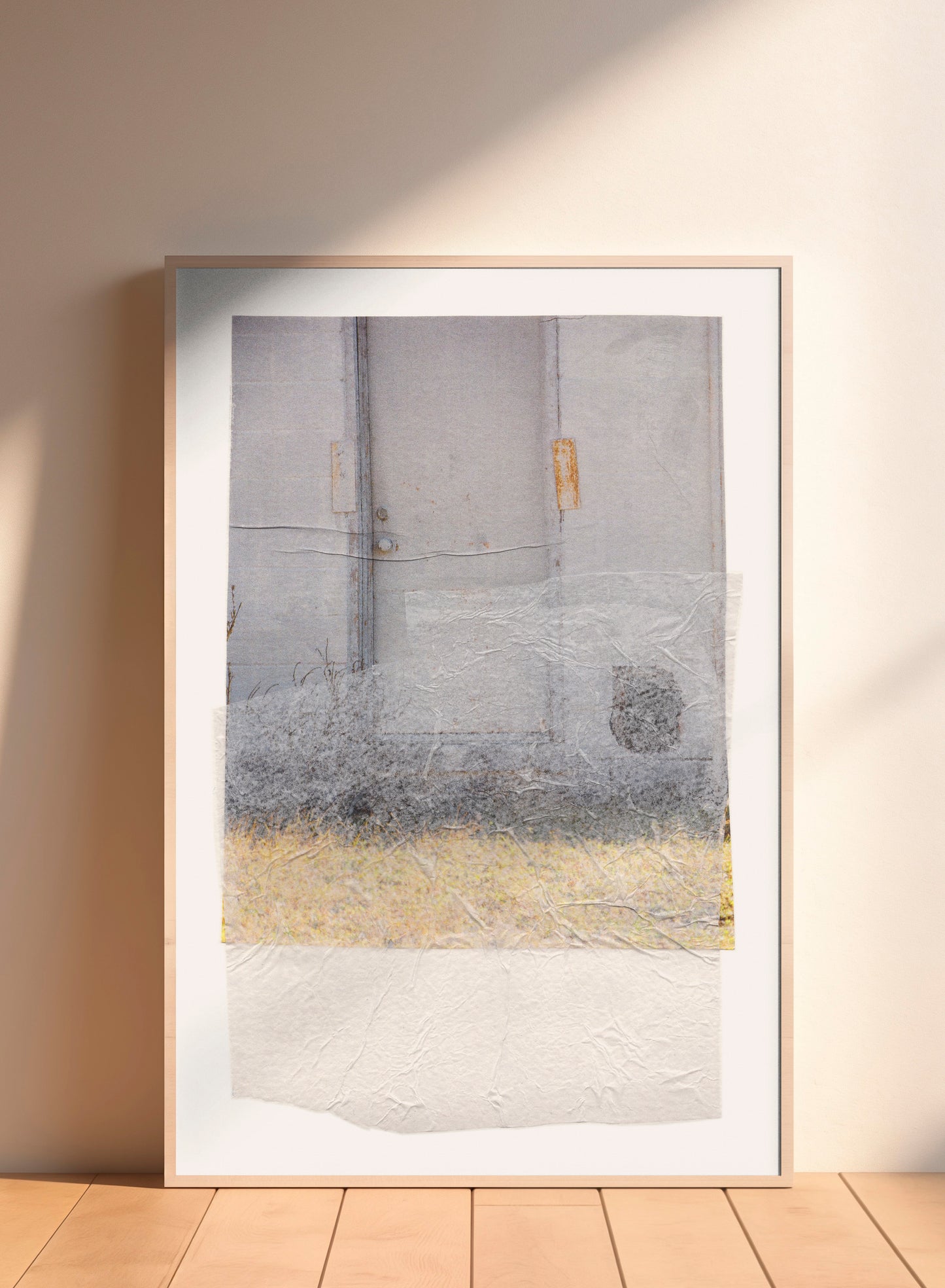 Large-scale gray abstract collage with soft earth tones and a textured surface in a wood frame.