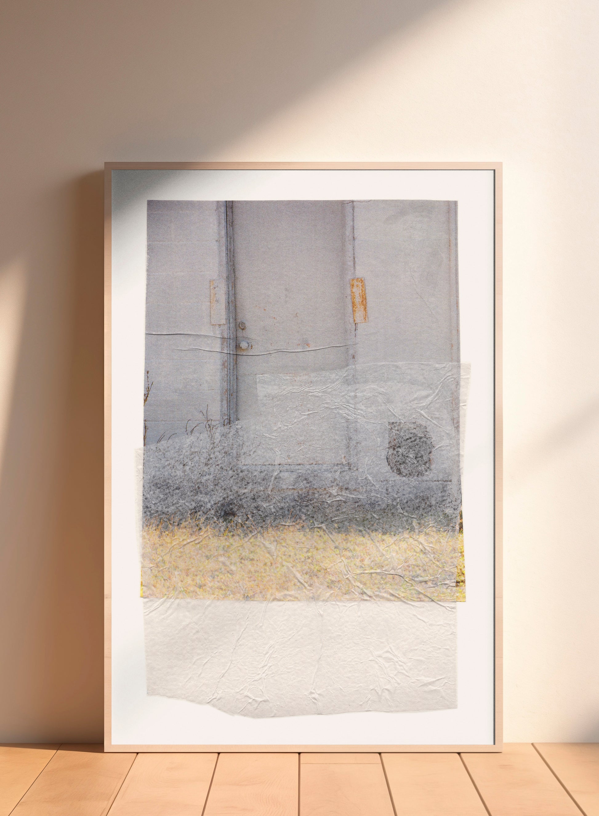 Large-scale gray abstract collage with soft earth tones and a textured surface in a wood frame.