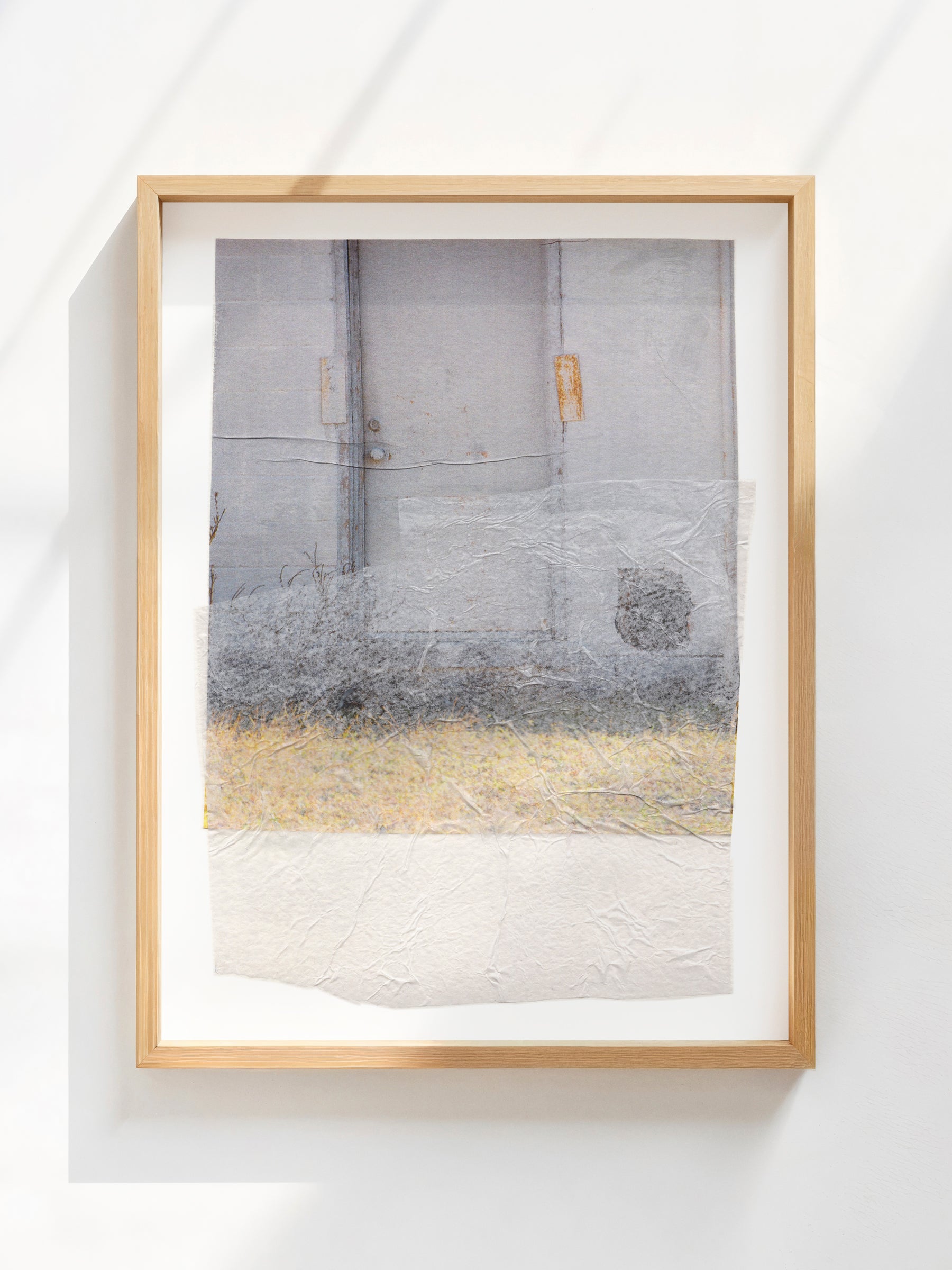 Gray, beige, and white textured abstract collage in a wood frame.