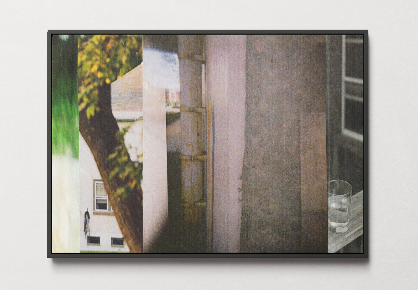 Framed canvas print of abstract photo collage with gray tones and green nature imagery.