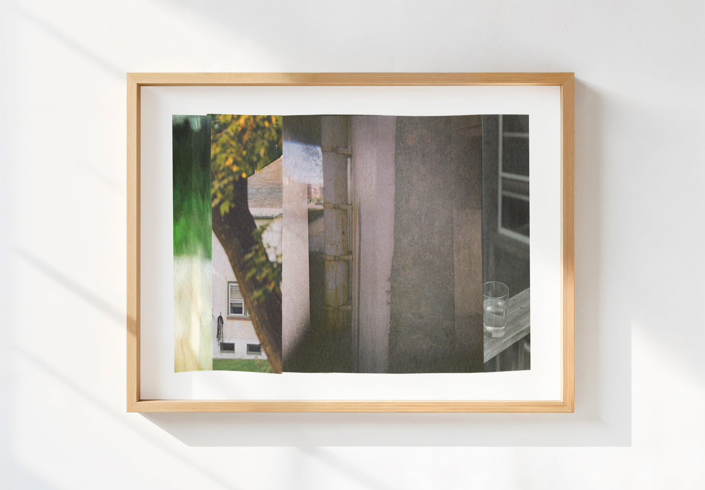 Framed abstract photo collage with gray tones and green nature imagery.