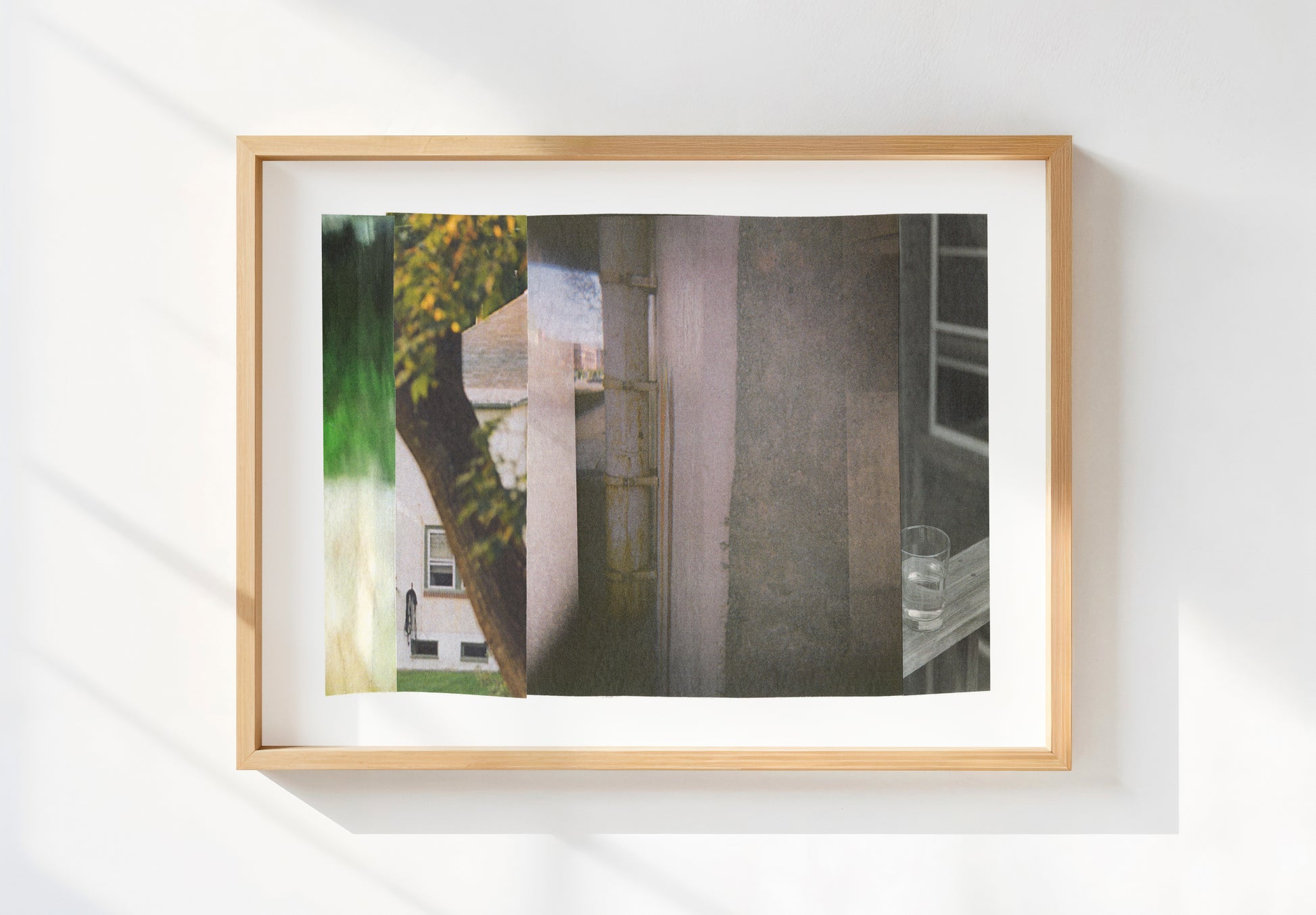 Framed abstract photo collage with gray tones and green nature imagery.