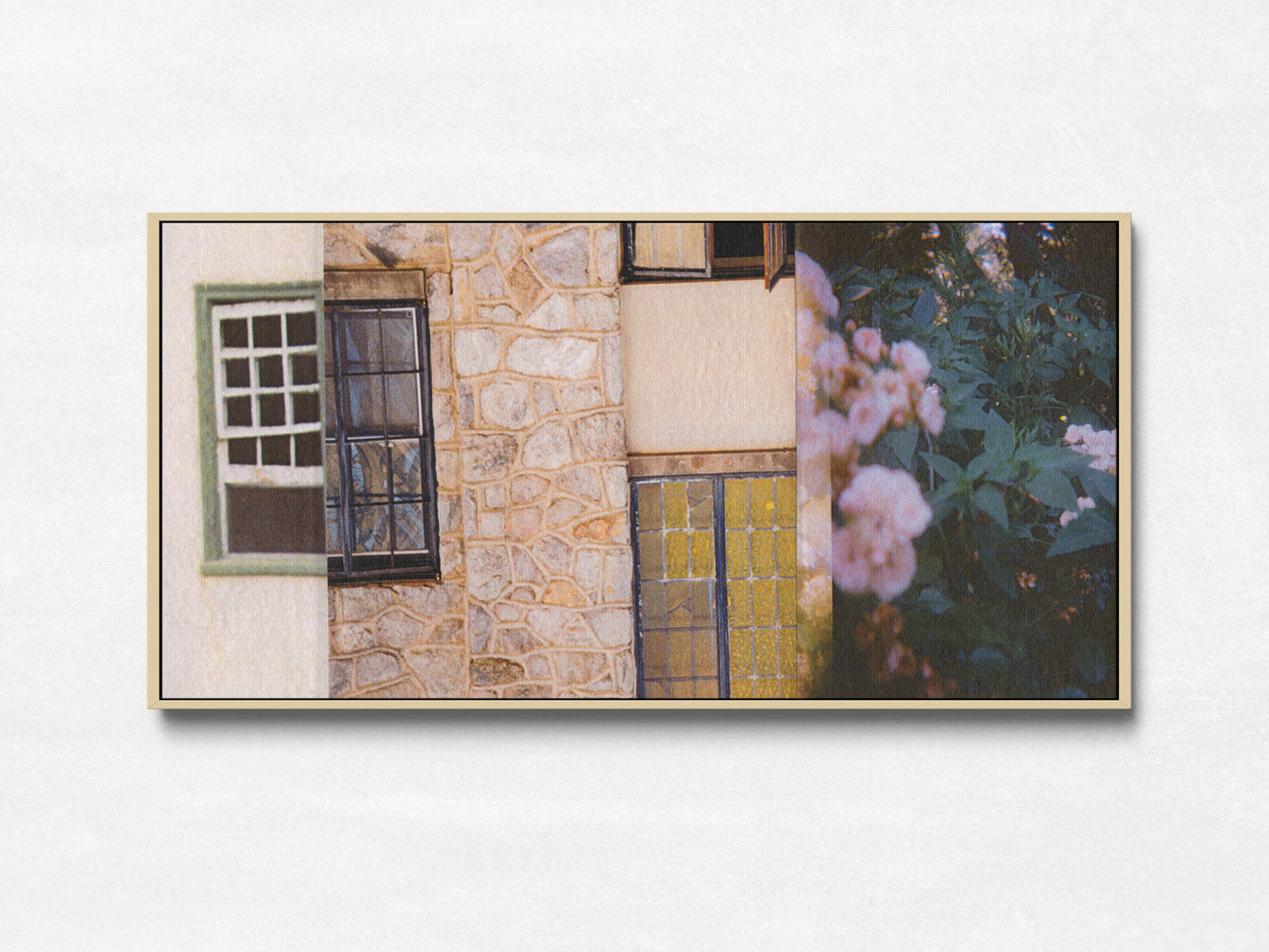 Pink, green, and cream collage of a stone wall with windows, a door, and flowers in oak floater frame.