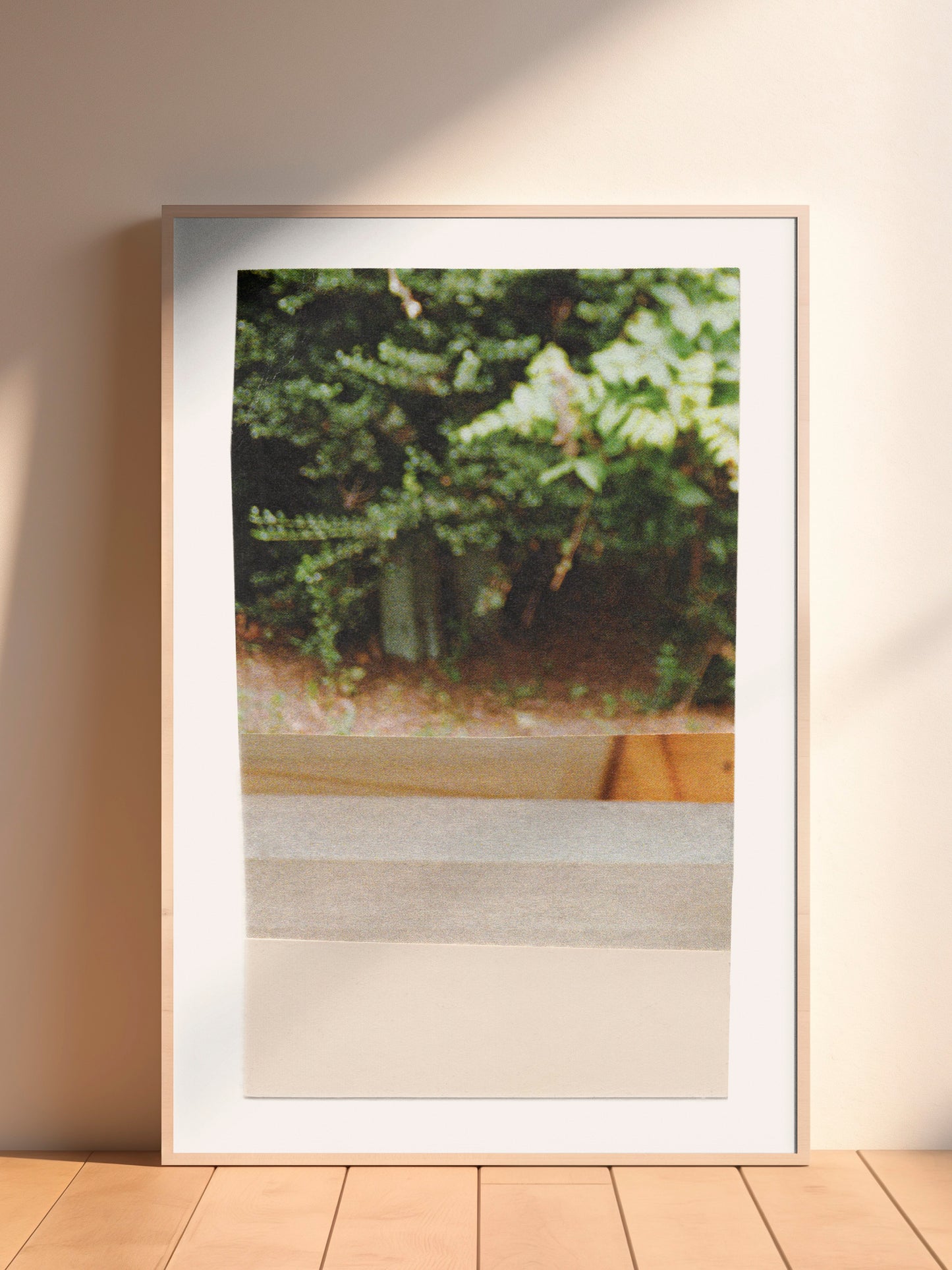Framed abstract mixed media collage art with green leaves and earth tones.