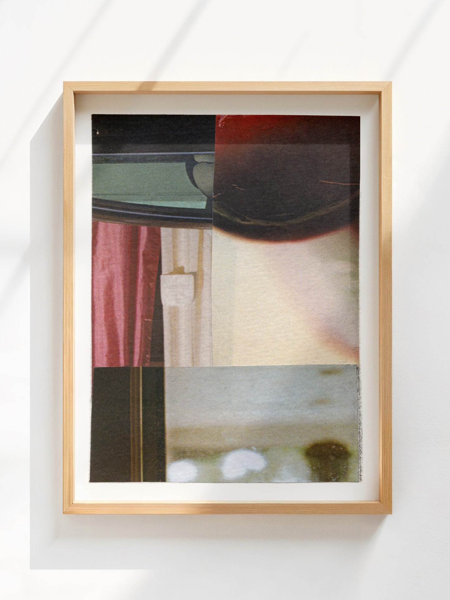 Framed abstract collage with geometric shapes and burgundy, cream, and black tones.