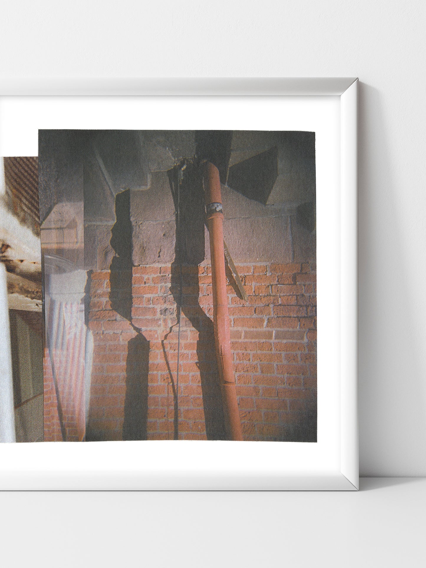 Framed abstract collage art with layered geometric shapes and shadows in neutral tones.