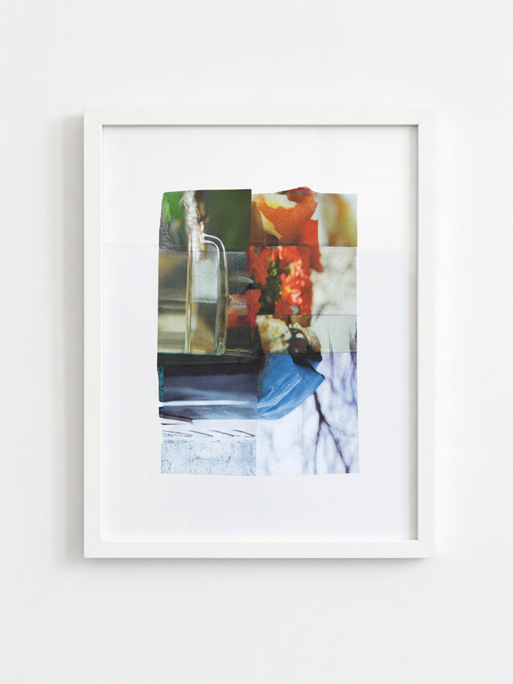 A framed abstract art print featuring a collage of colorful geometric and photographic elements, housed in a white frame and displayed against a light gray wall.