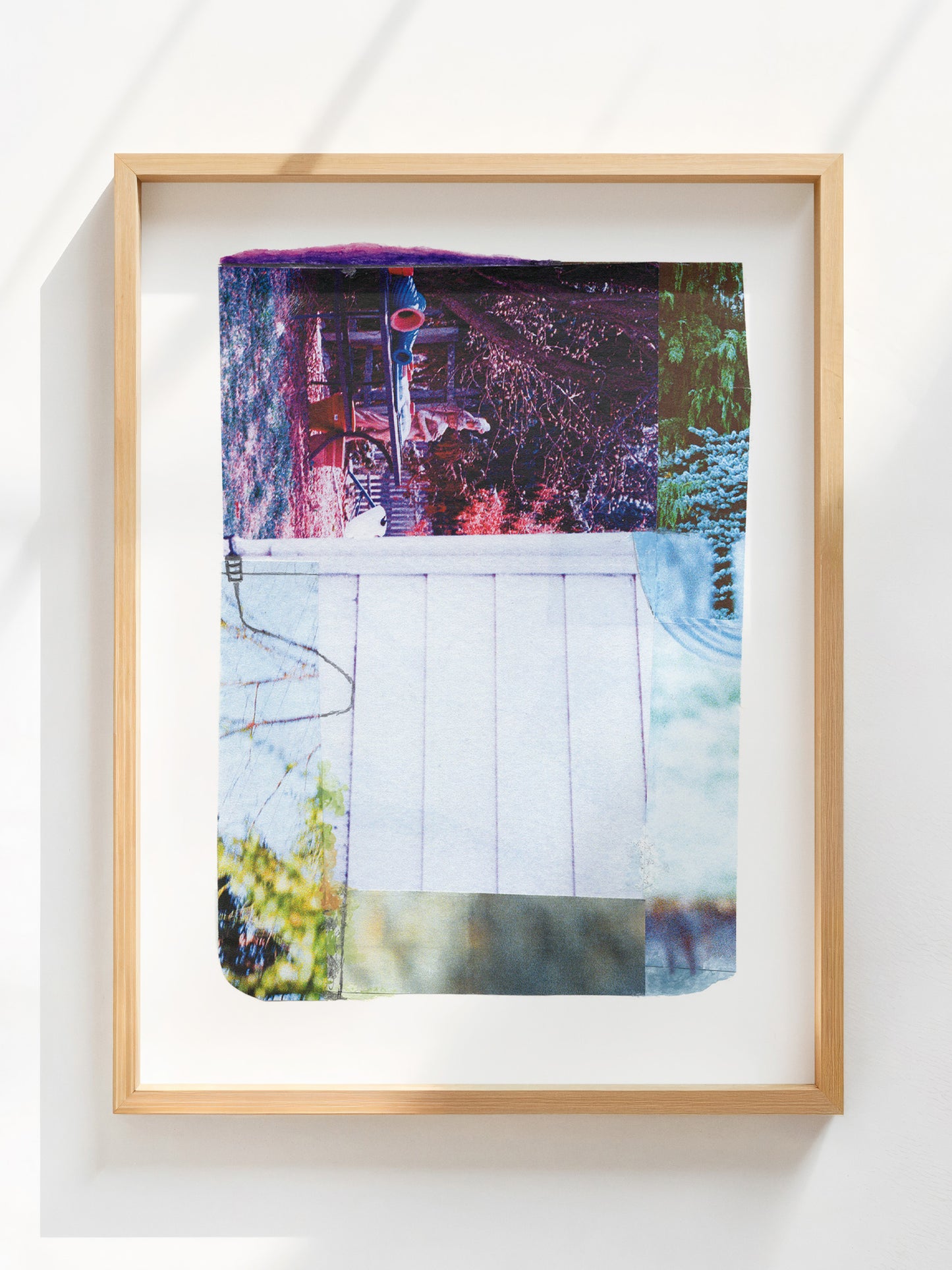 Abstract photo collage with pink, purple, white, and green tones in an oak frame.