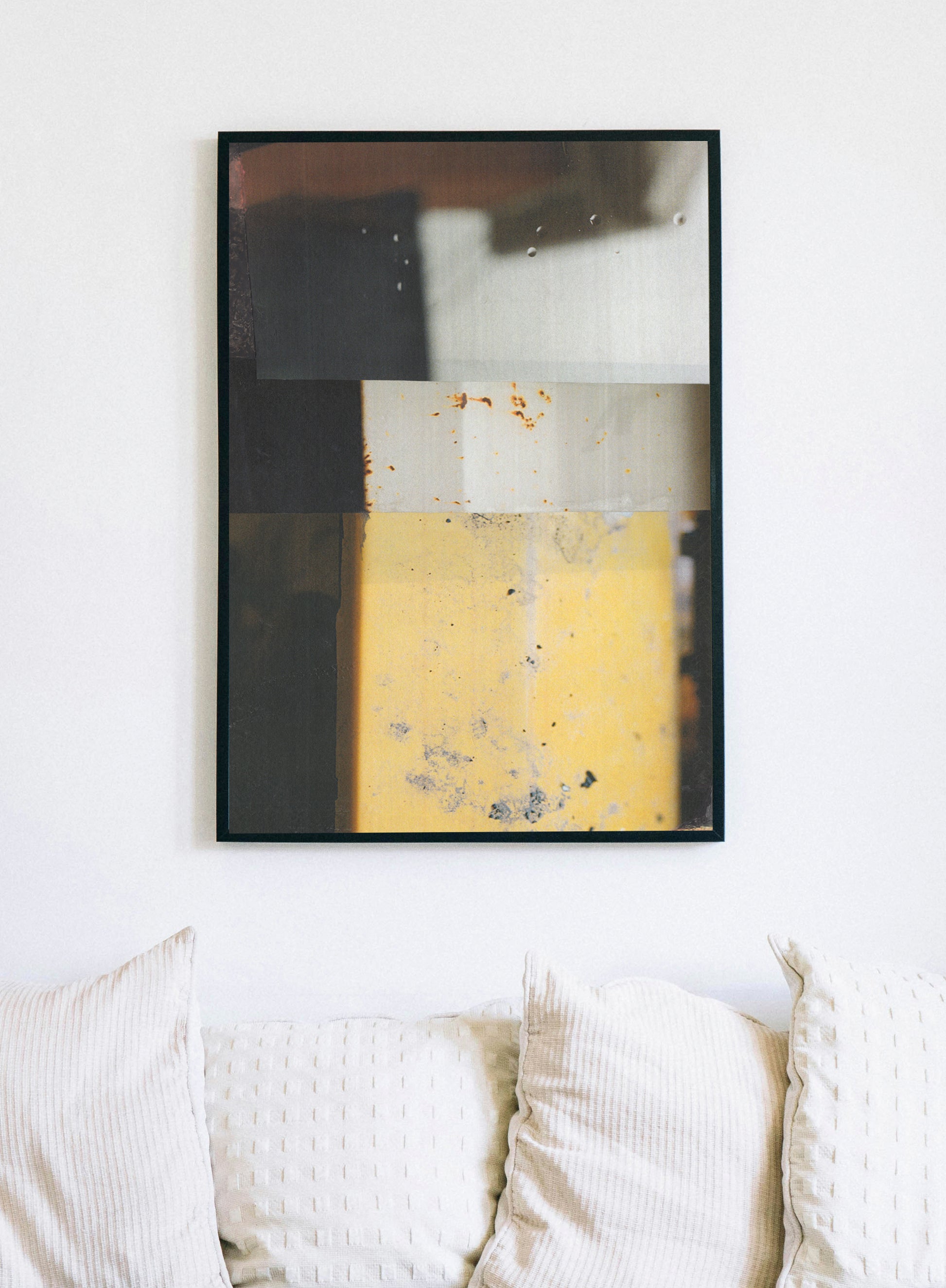 Framed abstract geometric art print with charcoal, cream, and golden yellow rectangular blocks.