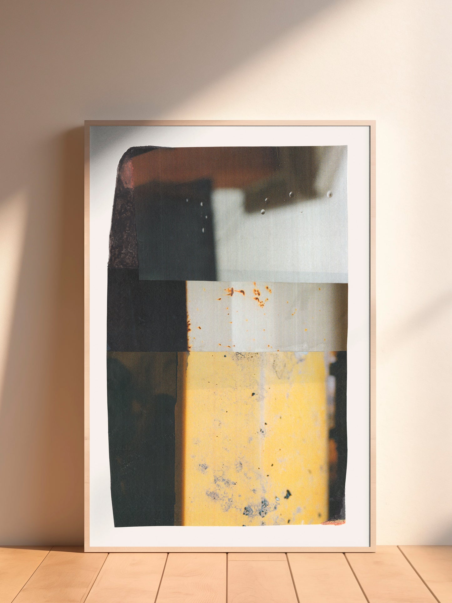 Geometric abstract collage art with neutral tones and yellows in a wood frame.