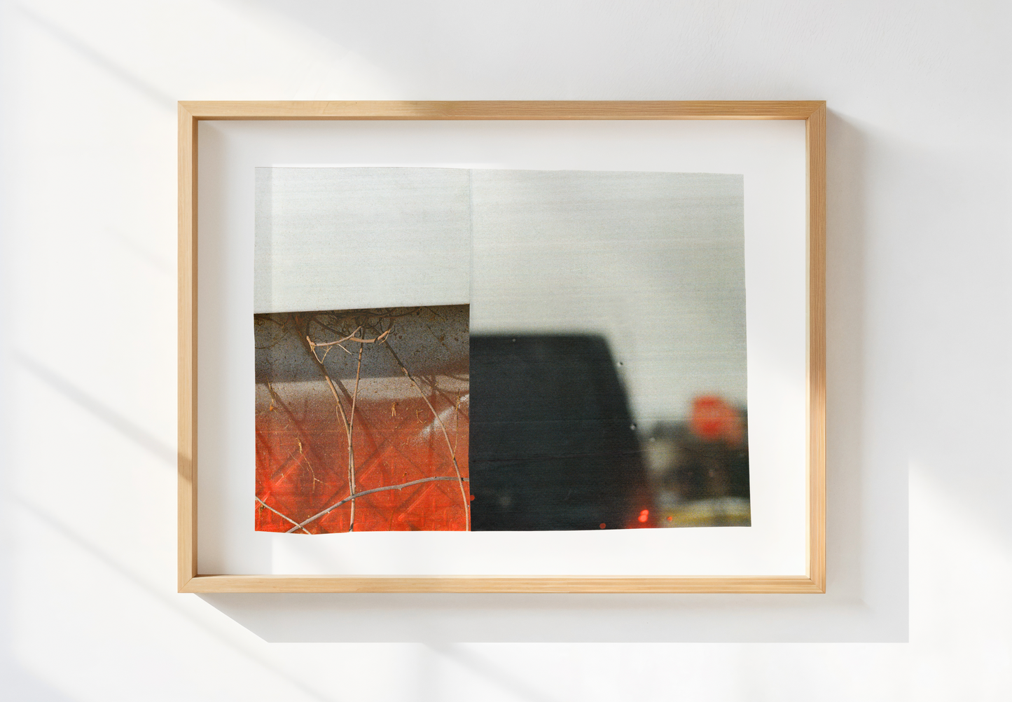 Black, red, and gray abstract photo collage art piece in a wood frame.