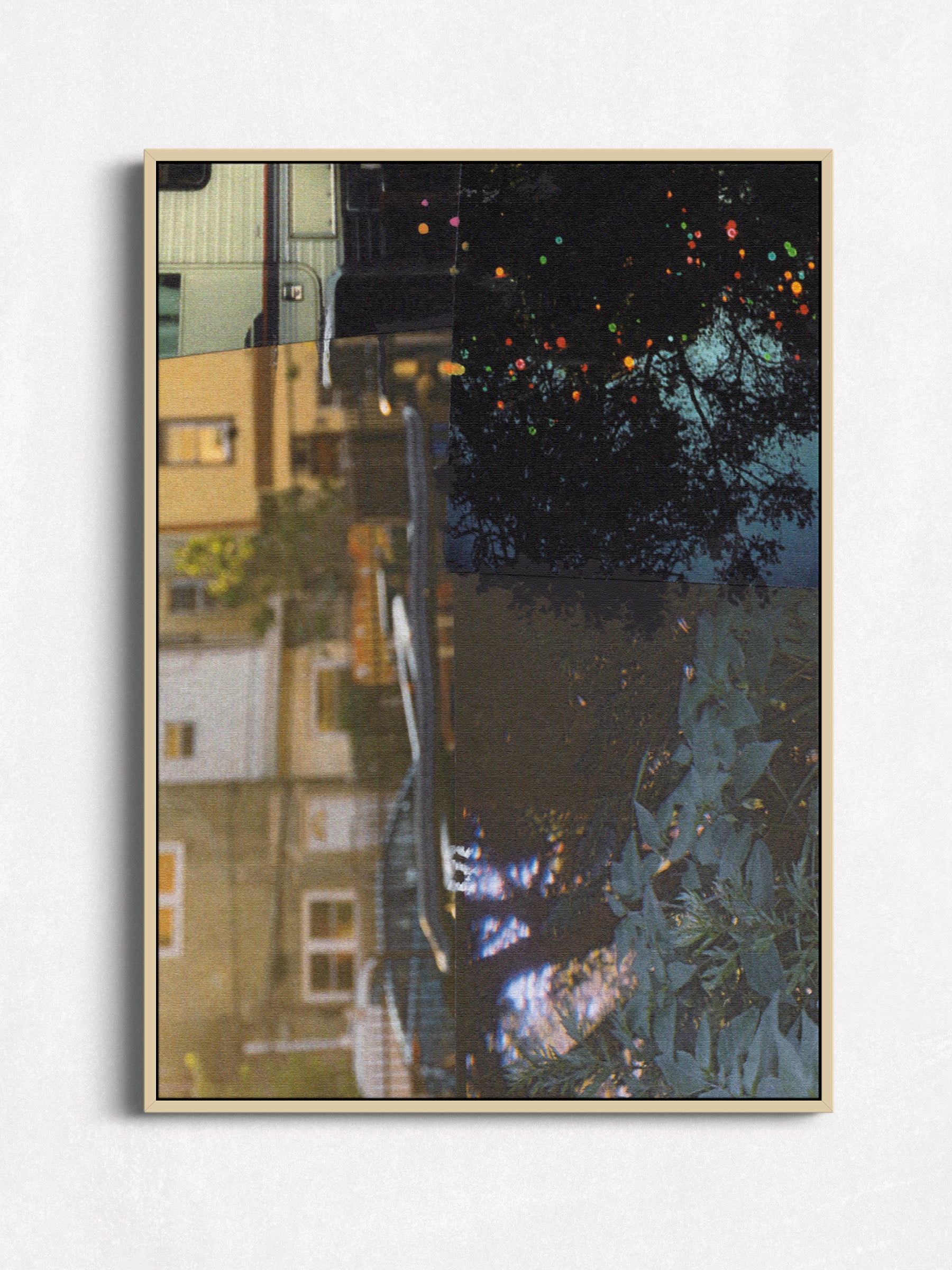 Abstract collage with architectural elements in dark blue, black, and earth tones in oak floater frame.