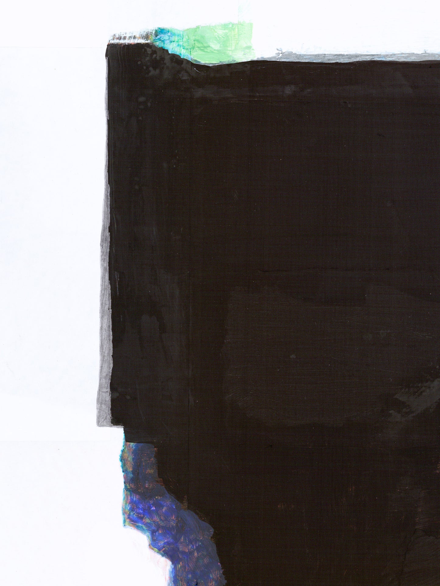 Close-up of a black surface with green and blue detailed edges.