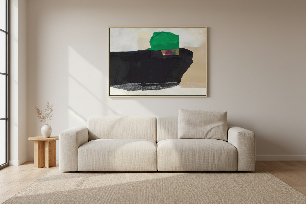A modern living room scene featuring a light beige textured sofa under a framed abstract wall art print. The artwork has bold blocks of black, green, beige, and gray.