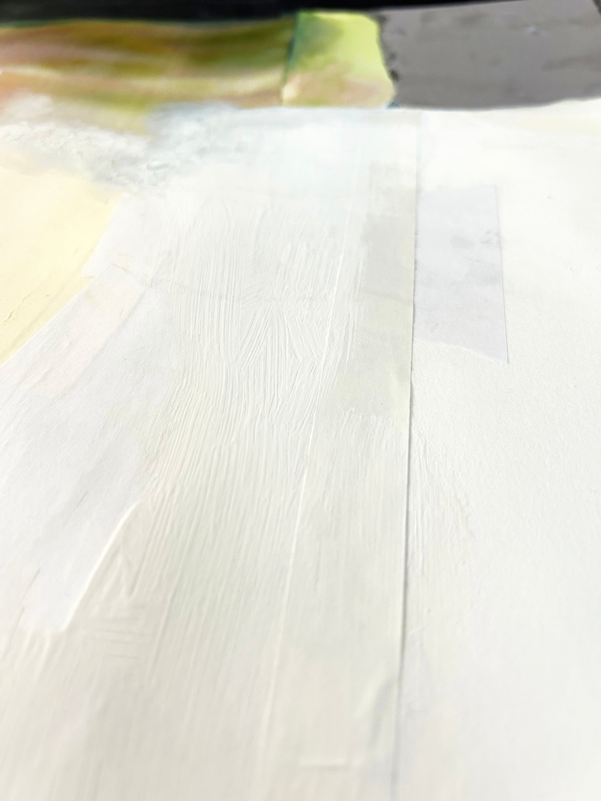 Detail of a textured painting with white, black, and green. 