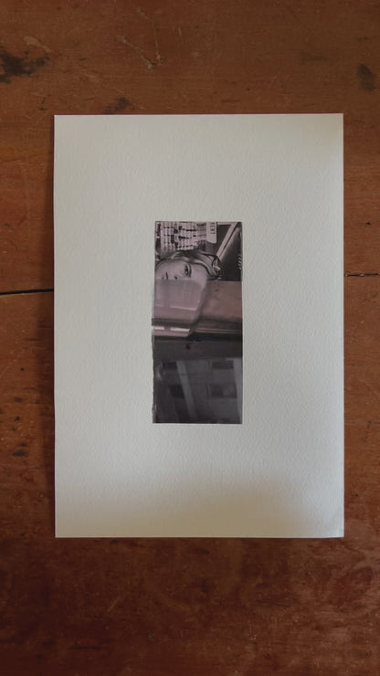 Black and white abstract collage featuring a woman's partially obscured face in a store aisle at the top, layered with reflective and textured images of urban architecture and surfaces below. The composition blends documentary realism with moody abstraction.