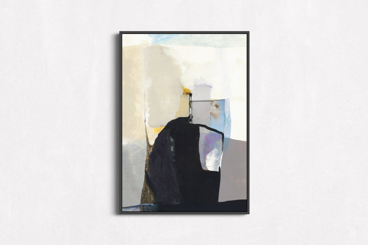 A framed abstract canvas print featuring a modern composition of black, cream, gray, light blue, and lavender brushstrokes, displayed on a textured white wall.